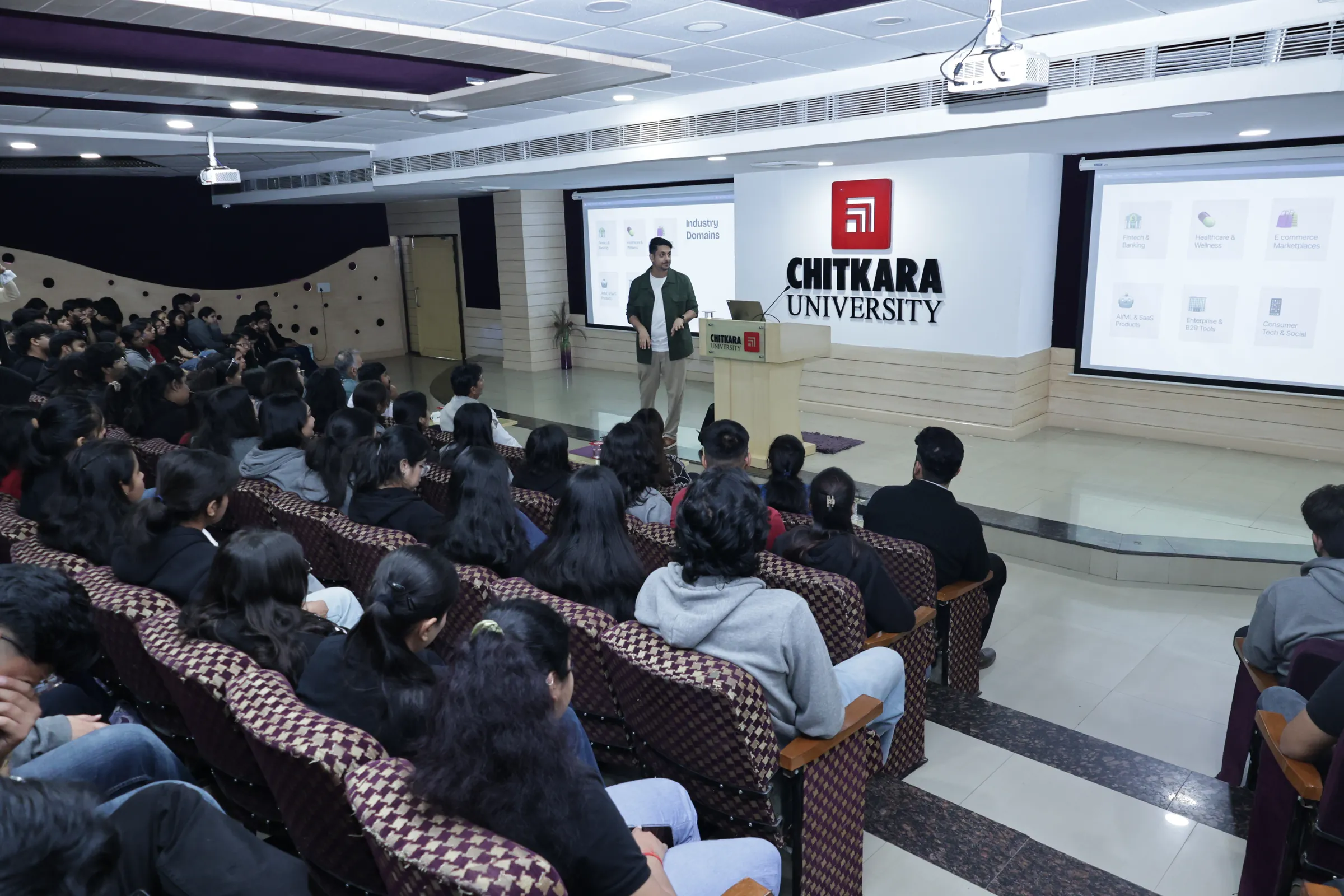 Ameet speaking to a full lecture hall of students at Chitkara University