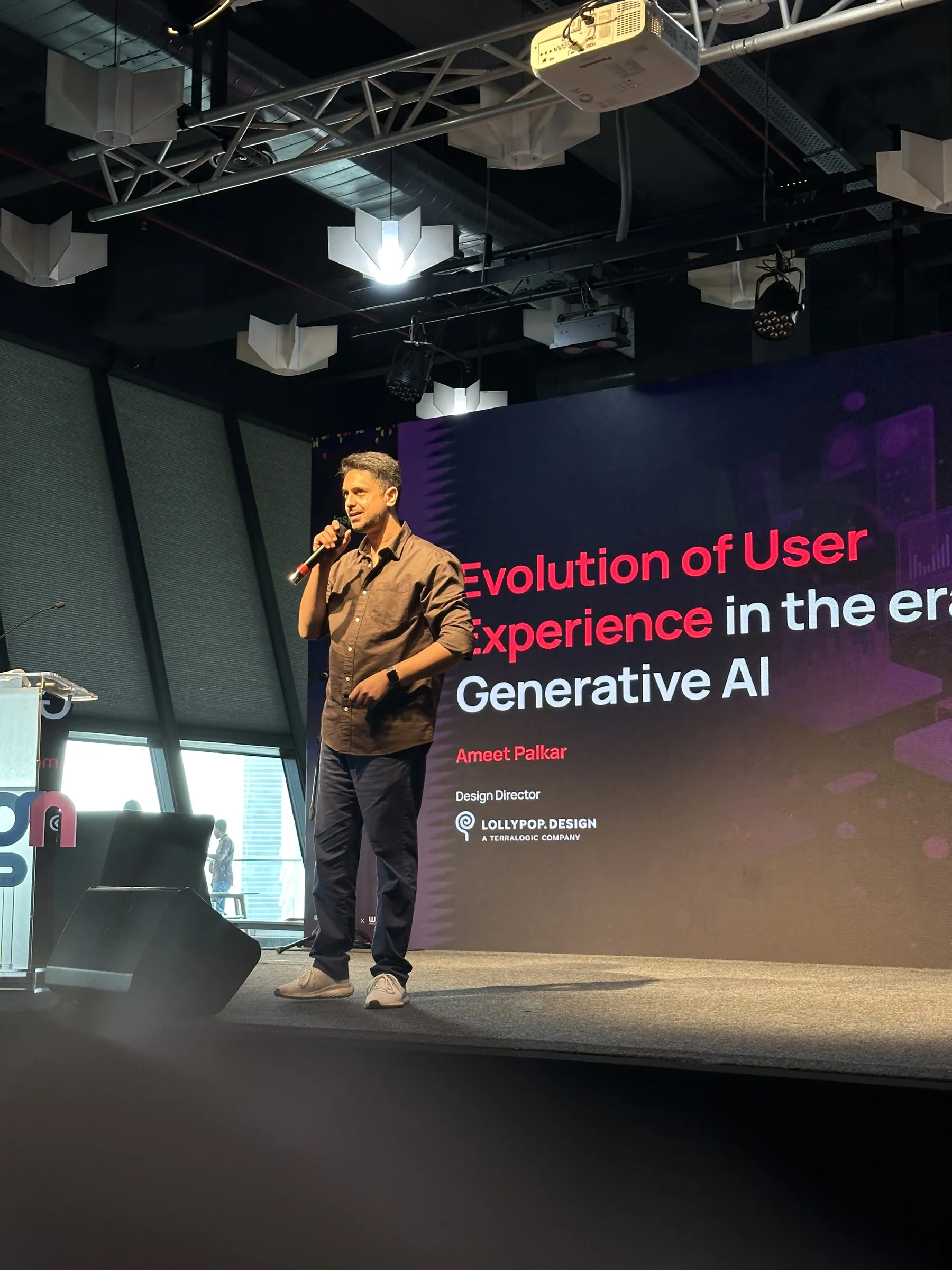 Ameet Palkar on stage at Salesforce Design Days beside his title slide on the evolution of user experience in the era of generative AI