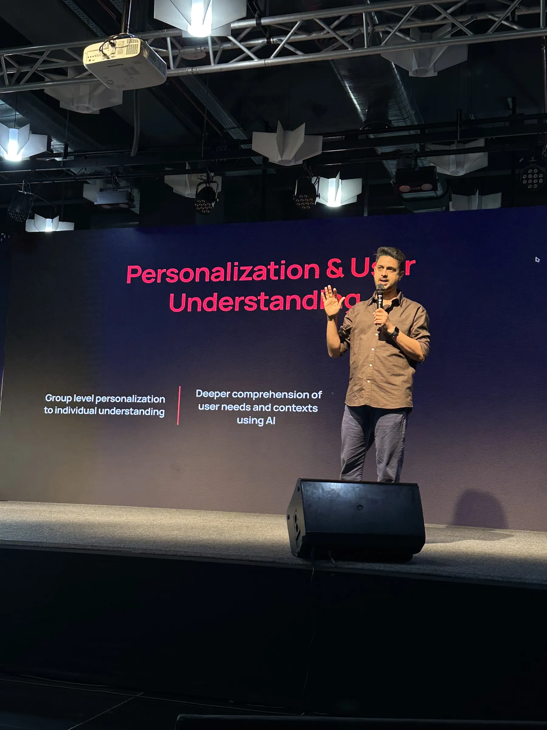 Ameet on stage in front of a slide about personalization and user understanding