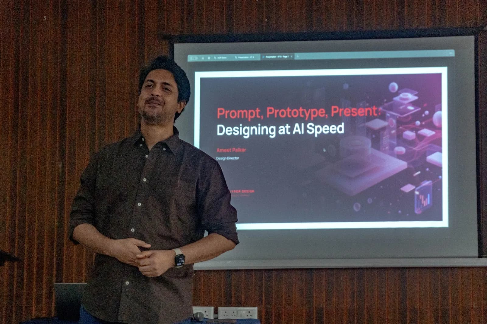 Ameet Palkar in front of his title slide, which reads Prompt, Prototype, Present: Designing at AI Speed